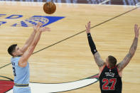 Memphis Grizzlies guard Grayson Allen, left, shoots against Chicago Bulls center Daniel Theis during the first half of an NBA basketball game in Chicago, Friday, April 16, 2021. (AP Photo/Nam Y. Huh)