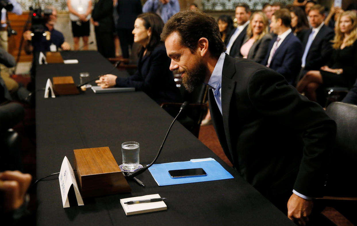 Twitter CEO Jack Dorsey takes his seat as he arrives with Facebook COO Sheryl Sandberg to testify before a Senate Intelligence Committee hearing on foreign influence operations on social media platforms on Capitol Hill in Washington, U.S., September 5, 2018. REUTERS/Jim Bourg