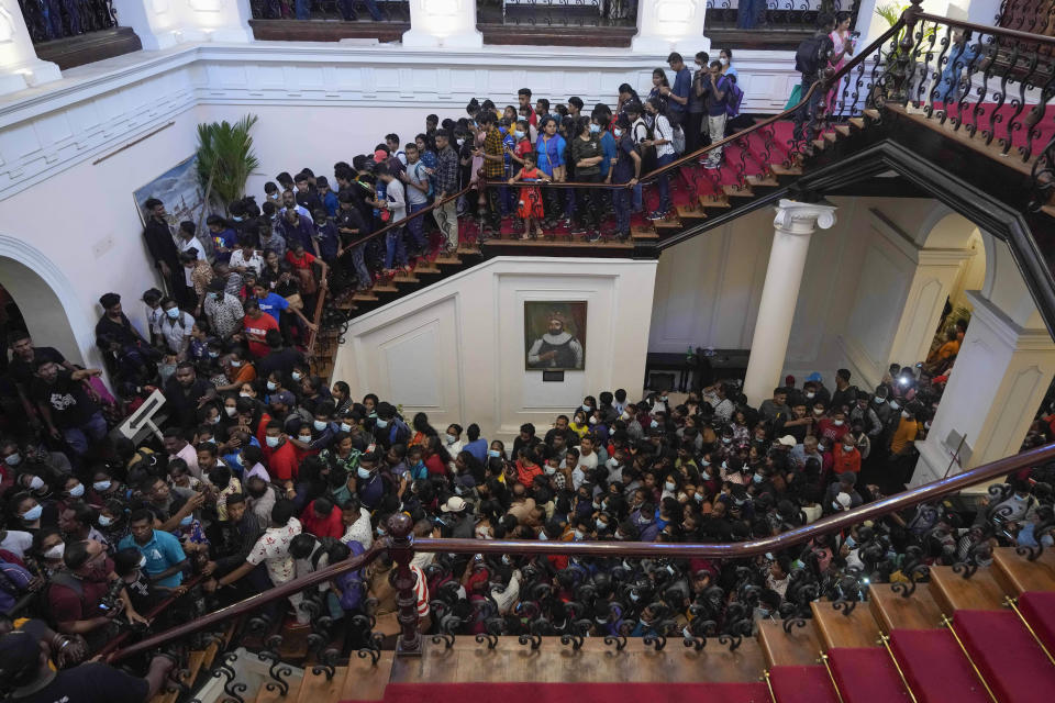 People throng President Gotabaya Rajapaksa’s official residence for the second day after it was stormed in Colombo, Sri Lanka, Monday, July 11, 2022. Sri Lanka is in a political vacuum for a second day Monday with opposition leaders yet to agree on who should replace its roundly rejected leaders, whose residences are occupied by protesters, angry over the country's economic woes. (AP Photo/Eranga Jayawardena)