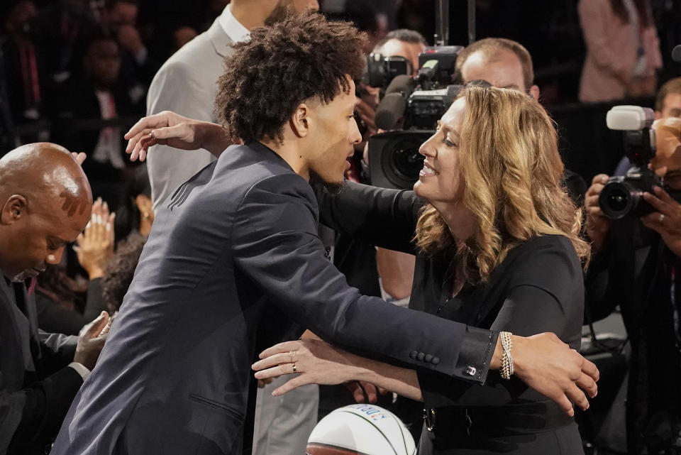 Cade Cunningham, left, hugs family and friends after being selected as the number one draft pick overall by the Detroit Pistons during the NBA basketball draft, Thursday, July 29, 2021, in New York. (AP Photo/Corey Sipkin)