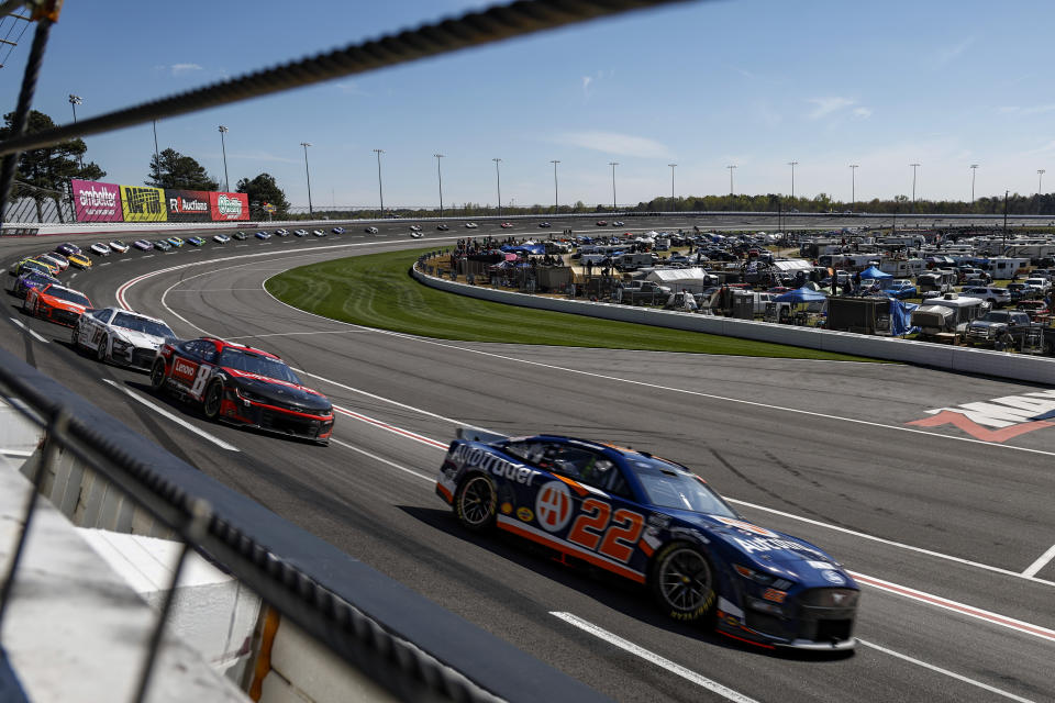 ]Joey Logano (22) leads a pack of cars through Turn 4 during the NASCAR Cup Series auto race at Atlanta Motor Speedway, Sunday, March 19, 2023, in Hampton, Ga. (AP Photo/Butch Dill)