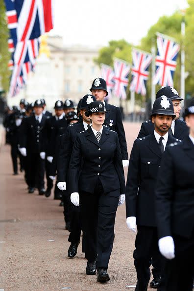 Metropolitan police officers are seen walking in formation down The Mall ahead of the State Funeral of Queen Elizabeth II on September 19, 2022, in London.