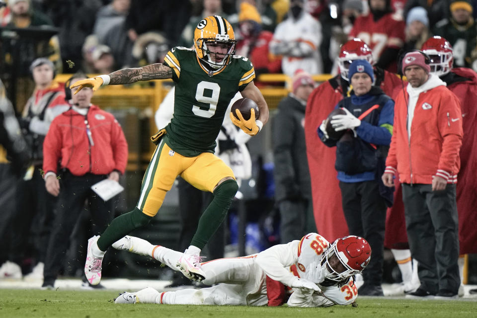 Green Bay Packers wide receiver Christian Watson (9) runs after a catch past Kansas City Chiefs cornerback L'Jarius Sneed (38) during the second half of an NFL football game Sunday, Dec. 3, 2023 in Green Bay, Wis. (AP Photo/Morry Gash)