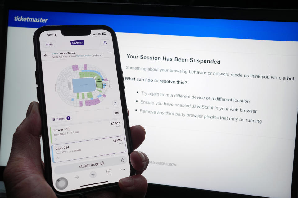 A person who has had their Ticketmaster session suspended on a laptop, as the StubHub website is displayed on a phone, detailing information about Oasis concert tickets for sale, in London. Oasis fans across the UK and Ireland who missed out on pre-sale tickets will be attempting to secure their place at the band's reunion concerts during Saturday's general sale. Issue date: Saturday August 31, 2024. (Photo by Yui Mok/PA Images via Getty Images)
