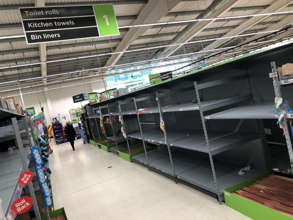 A view of empty shelves as toilet roll and kitchen roll are almost sold out in an Asda supermarket in Bearsden, East Dunbartonshire. UK shoppers are stockpiling toilet paper, pasta, hand sanitiser and tinned foods as fears grow over the spread of the coronavirus.