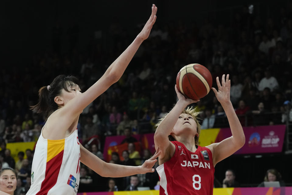 China's Han Xu, left, attempts to block a shot at goal from Japan's Maki Takada during the Asia Cup women's basketball final in Sydney, Australia, Sunday, July 2, 2023. (AP Photo/Mark Baker)