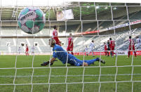 Goalkeeper Robin Zentner of Mainz fails to safe the ball during the German Bundesliga soccer match between Borussia Moenchengladbach and SV Mainz 05 in Moenchengladbach, Germany, Saturday, Feb. 20, 2021. (Federico Gambarini/Pool via AP)