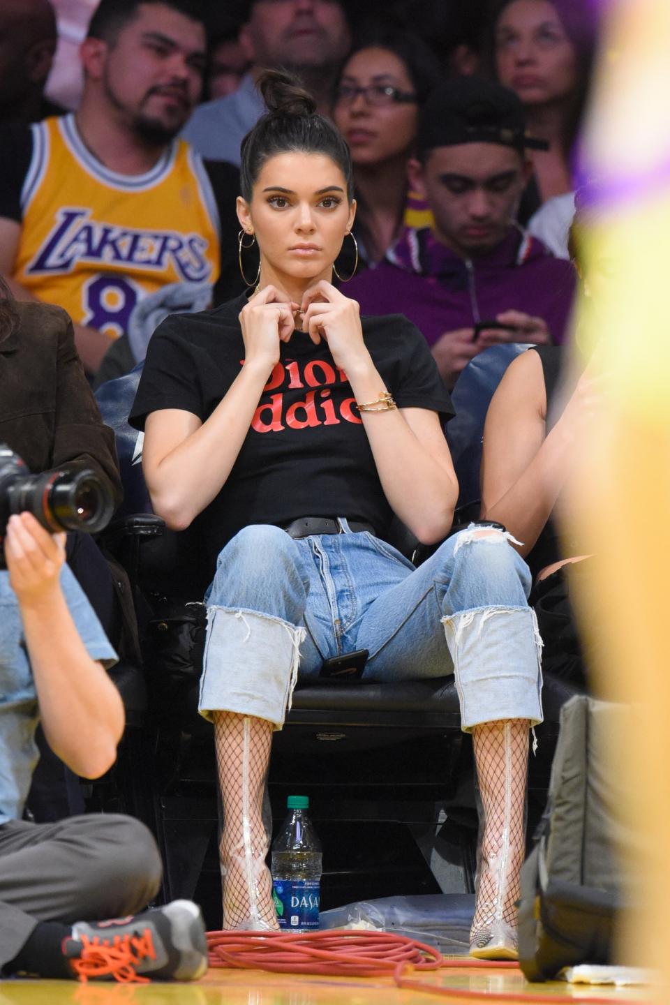 <p>Kendall has perfected her side court style over the years. We are loving the fishnets and transparent boots look, plus, the ‘Dior addict’ tee is just too true. [Photo: Getty] </p>