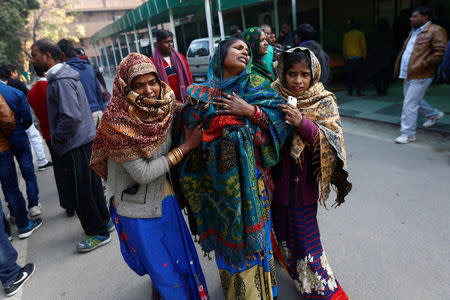 Relatives of a victim, who was who was killed in Saturday’s fire in a warehouse, mourn as they wait outside a hospital in New Delhi, India, January 21, 2018. REUTERS/Adnan Abidi