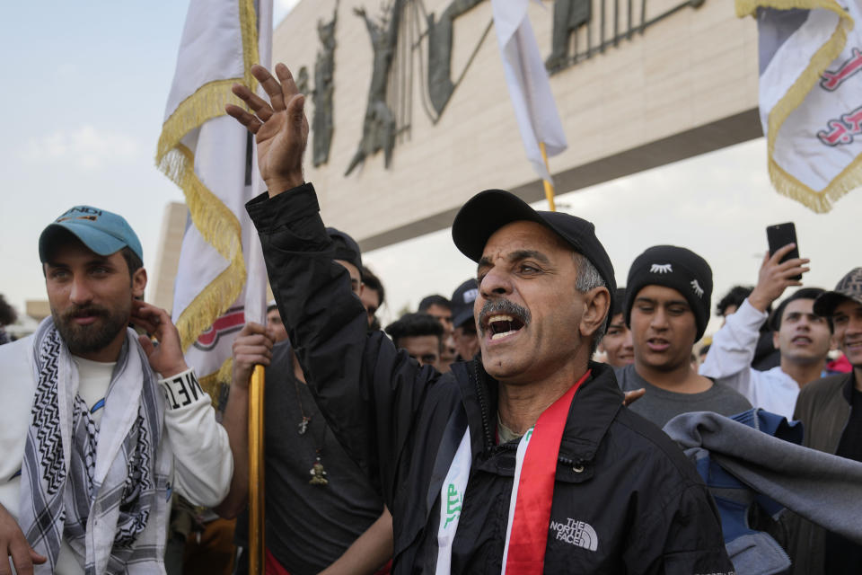 Protesters gather in Tahrir Square in Baghdad, Iraq, Friday, Feb. 3, 2023. As the Iraqi currency continued its slide, some 150 protesters gathered Friday in central Baghdad, call on the government to take action to stop the crisis. (AP Photo/Hadi Mizban)