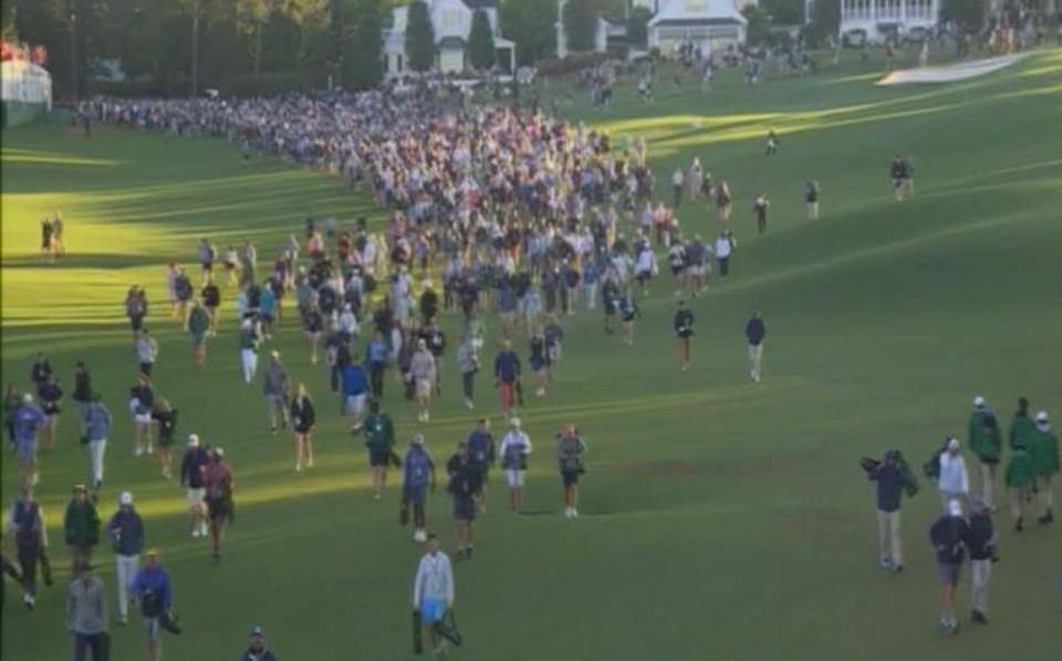 Patrons speed walk between holes at The Masters at Augusta