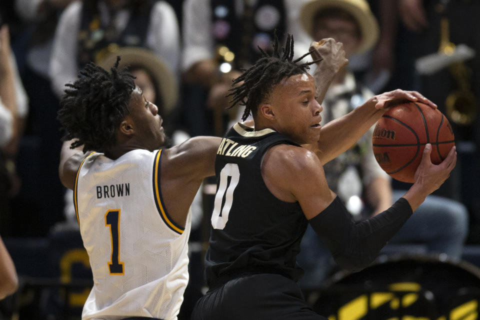 Colorado guard Shane Gatling (0) grabs a defensive rebound in front of California guard Joel Brown (1) during the first half of an NCAA college basketball game Thursday, Feb. 27, 2020, in Berkeley, Calif. (AP Photo/D. Ross Cameron)