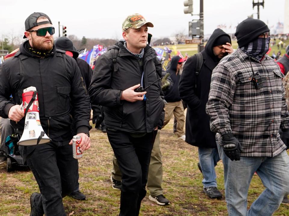 Three accused members of the hate group Proud Boys march on the Capitol on January 6. From left, Ethan Nordean, Zachary Rehl and Joseph Biggs.