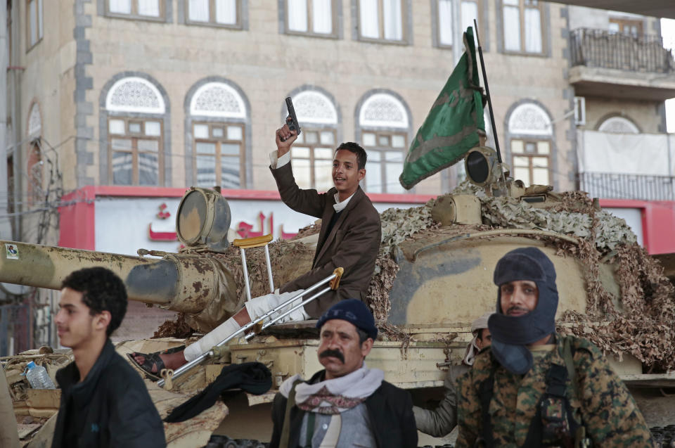 FILE - In this Dec. 4, 2017, file photo, Houthi Shiite fighters guard a street leading to the residence of former Yemeni President Ali Abdullah Saleh, in Sanaa, Yemen. A senior leader from Yemen’s Houthi rebels says that for the sake of peace efforts the group will halt rocket fire into Saudi Arabia, its larger northern neighbor who is leading a U.S.-backed Arab coalition to restore Yemen’s internationally recognized government. (AP Photo/Hani Mohammed, File)