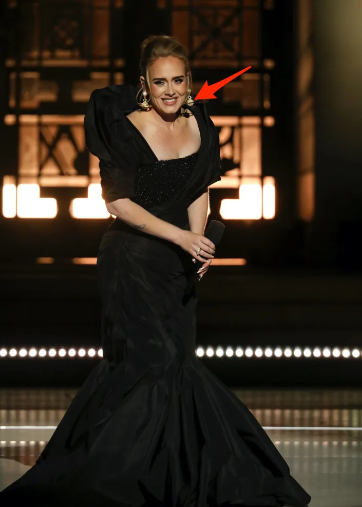 Adele wore a pair of a pair of gold Saturn earrings by Schiaparelli.