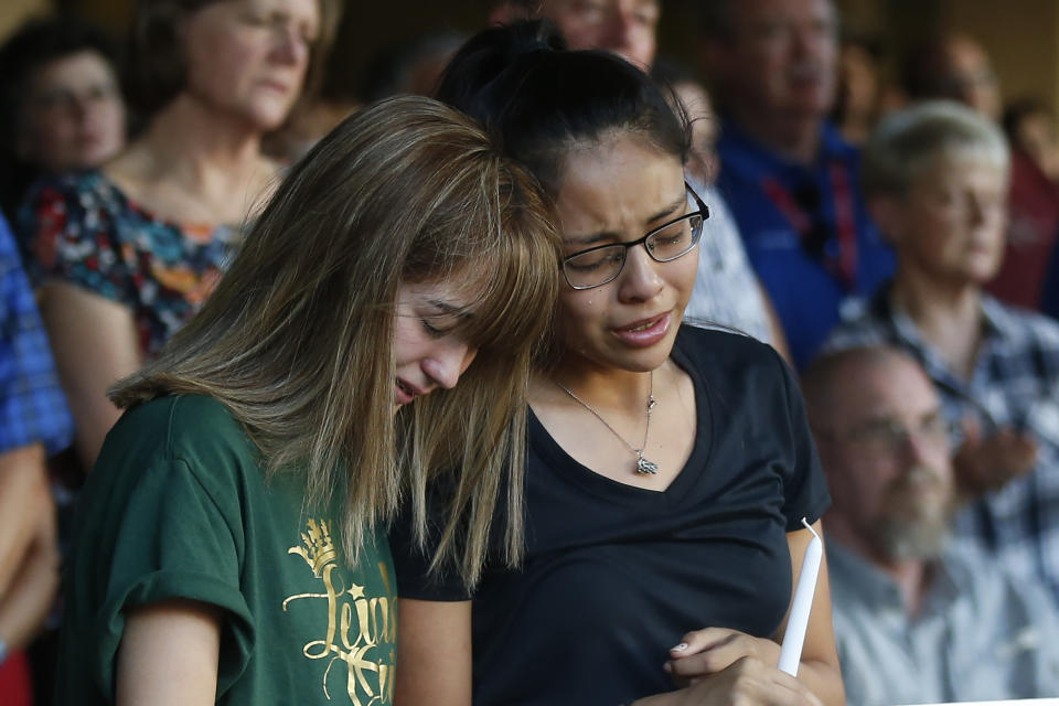 CORRECTS SPELLING OF VICTIM'S FIRST NAME TO LEILAH INSTEAD OF LEILA - High School students Celeste Lujan, left, and Yasmin Natera mourn their friend Leilah Hernandez, one of the victims of the Saturday shooting in Odessa, at a memorial service Sunday, Sept. 1, 2019, in Odessa, Texas. (AP Photo/Sue Ogrocki)