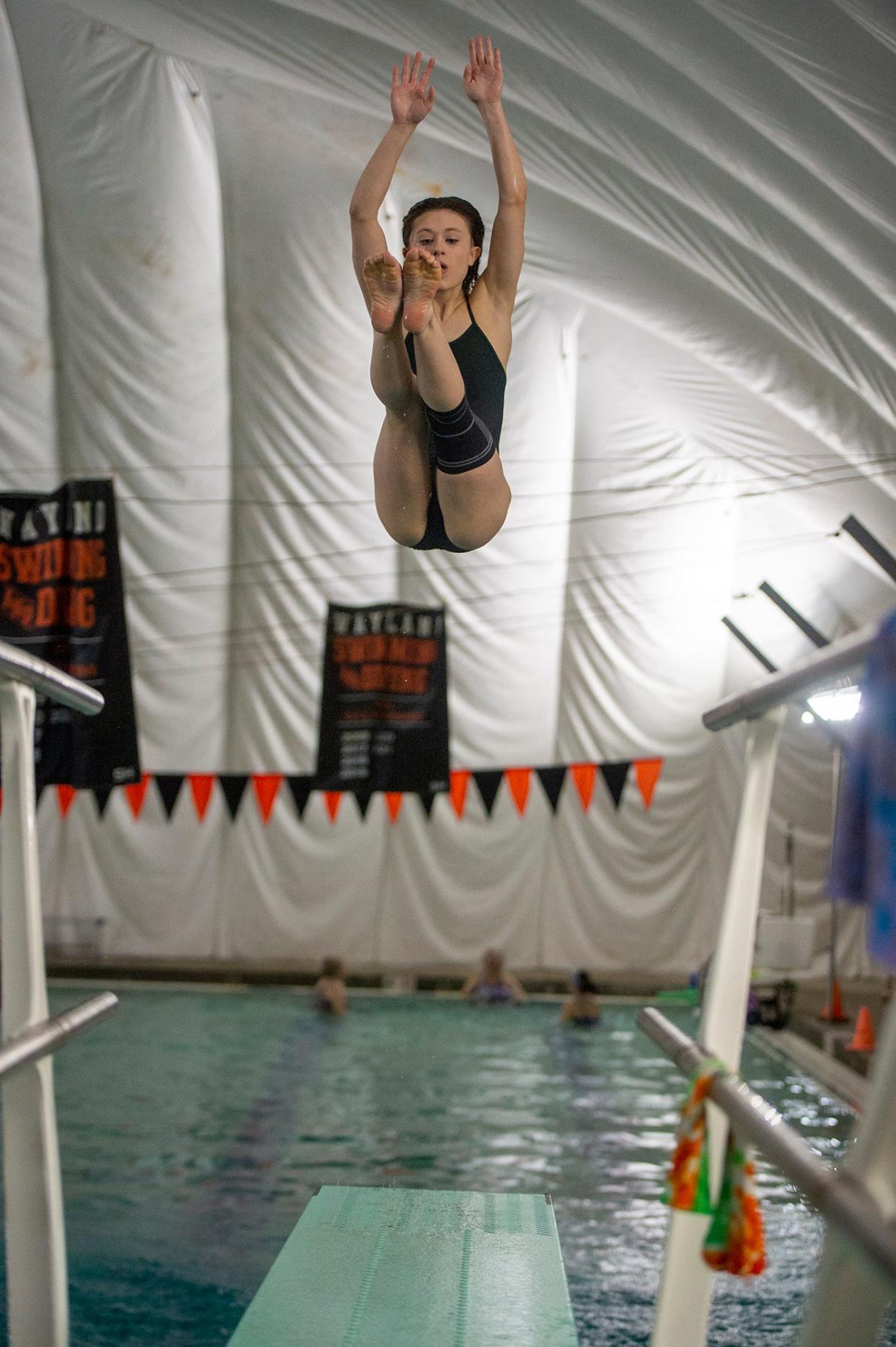 Hopkinton High School diver Eve Weatherhead practices with the Wayland High School swim team, Jan. 19, 2023.