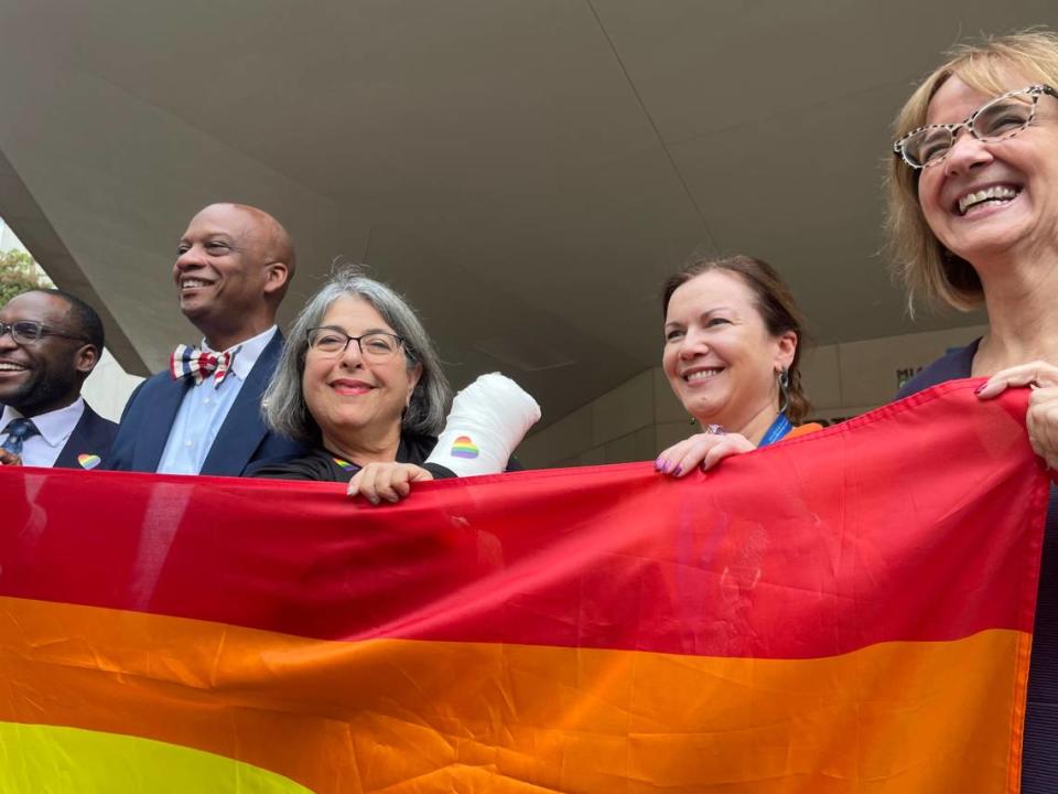 Miami-Dade Mayor Daniella Levine Cava, third from left, looks over a Pride flag before it was raised above the Stephen P. Clark County Hall facility on Wednesday, June 7, 2023. To her immediate right is Oliver Gilbert, chair of the Miami-Dade County Commission, and two down from her left is Eileen Higgins, a Miami-Dade commissioner. Also photographed: State Sen. Shevrin Jones, D-Miami Gardens and Sarah Kavanagh, Ireland’s consul general in Miami. DOUGLAS HANKS/dhanks@miamiherald.com