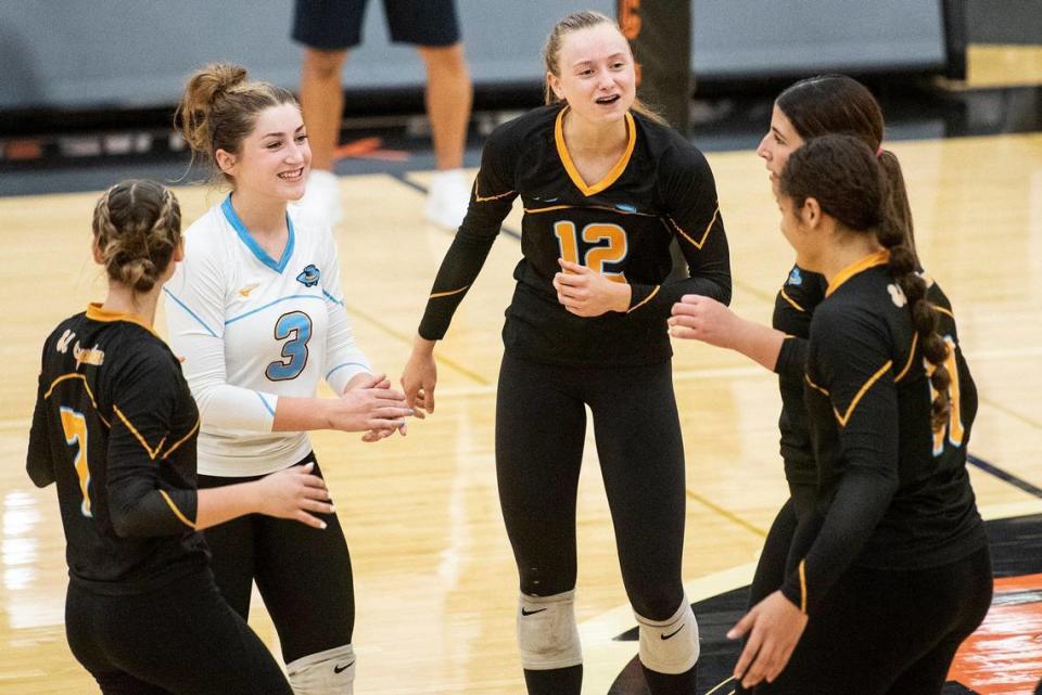 El Capitan players celebrate a point during a match against Merced at Merced High School in Merced, Calif., on Wednesday, Oct. 4, 2023. The Gauchos swept the Bears 3-0.