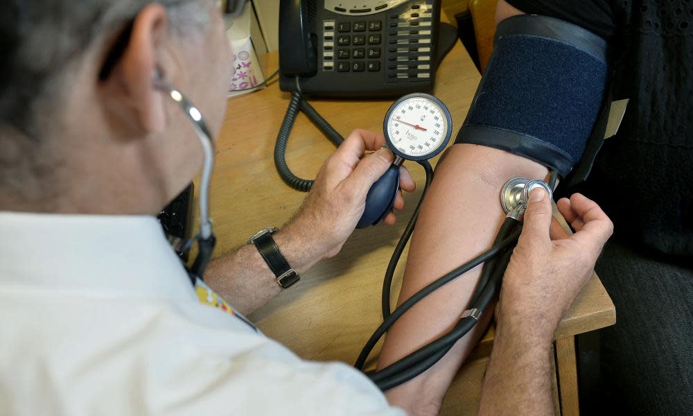 GP checking a patient’s blood pressure