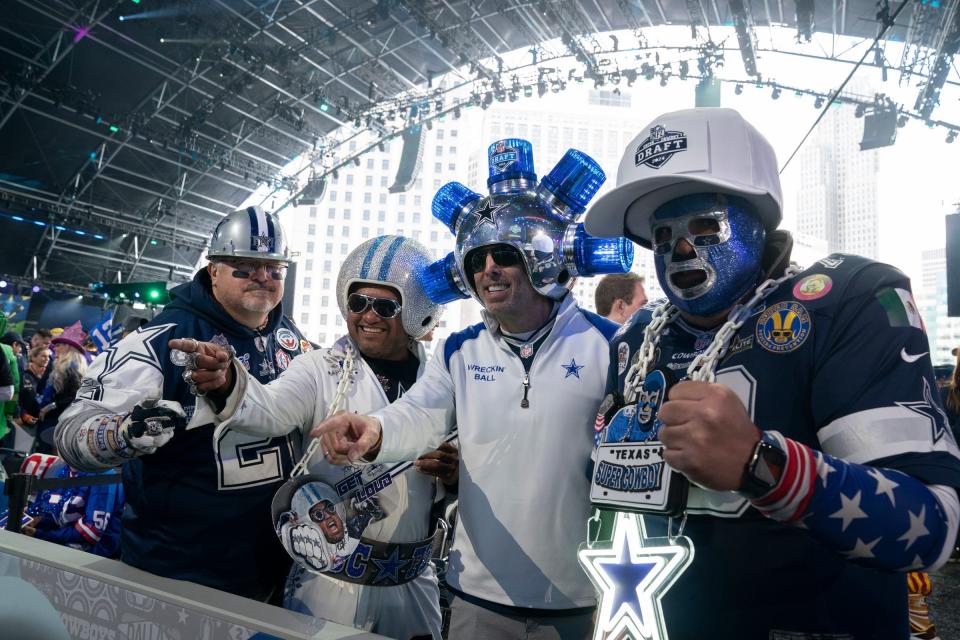 Dallas Cowboys fan pose in the main theater Thursday night for the first day of the NFL draft in Detroit. Their team selected Oklahoma tackle Tyler Guyton near the end of the first round after dropping back five spots in a trade with the Lions.