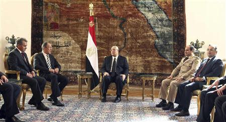 Egypt's interim President Adly Mansour (C), General Abdel Fattah al-Sisi (2nd R) and Foreign Minister Nabil Fahmy (R) meet with Russia's Foreign Minister Sergei Lavrov (2nd L) and Defence Minister Sergei Shoigu (L) at El-Thadiya presidential palace in Cairo, November 14, 2013. REUTERS/Amr Abdallah Dalsh