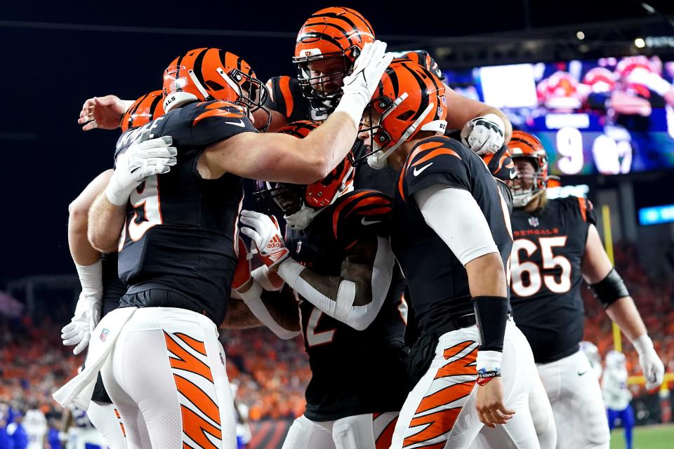 Bengals quarterback Joe Burrow (9) celebrates a touchdown throw with tight end Drew Sample (89) and other teammates during the second quarter against the Bills at Paycor Stadium in Cincinnati on Nov. 5, 2023.