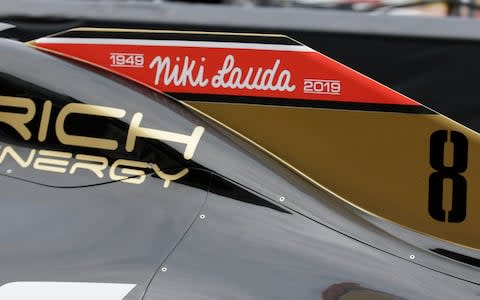 The name of three-time Formula One world champion Niki Lauda is written on Romain Grosjean's Haas race car, top, during the second practice session at the Monaco racetrack, in Monaco, Thursday, May 23, 2019. Three-time Formula One world champion Niki Lauda, who won two of his titles after a horrific crash that left him with serious burns and went on to become a prominent figure in the aviation industry, has died on May 21, 2109. He was 70 - Credit: AP