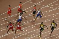 Mike Rodgers of the U.S. (bottom L) receives the baton from his teammate Tyson Gay outside the exchange area as Usain Bolt of Jamaica (2nd R) receives the baton from his teammate Nickel Ashmeade (R) in the men's 4 x 100 metres relay final during the 15th IAAF World Championships at the National Stadium in Beijing, China, August 29, 2015. REUTERS/Fabrizio Bensch