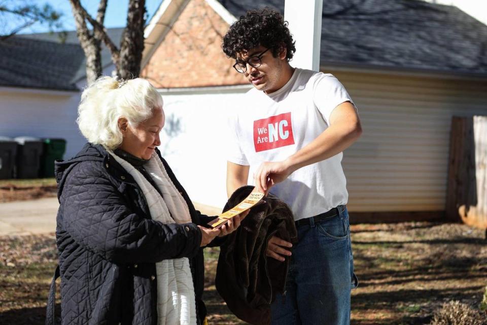 Dolores Gomez, left, and Nicolas Contreras, canvassers with Action NC, go door to door of rental homes in the Hidden Valley community on Tuesday, January 24, 2023.