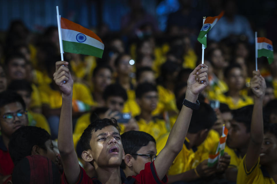 Schoolchildren celebrate the successful landing of spacecraft Chandrayaan-3 on the moon, in a school in Guwahati, India, Wednesday, Aug. 23, 2023. India has landed a spacecraft near the moon's south pole, an unchartered territory that scientists believe could hold vital reserves of frozen water and precious elements, as the country cements its growing prowess in space and technology. (AP Photo/Anupam Nath)