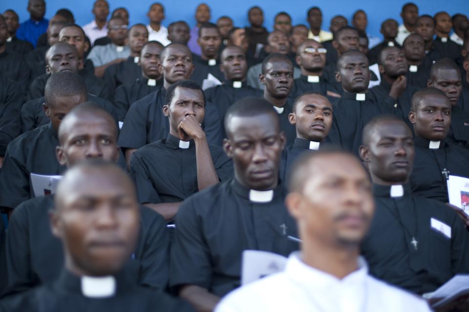 Seminarians attend the first Mass by newly-appointed Cardinal Chibly Langlois in Port-au-Prince, Haiti, Sunday, March 9, 2014. Langlois reminded Sunday's crowd at a soccer stadium that many would go hungry or wouldn't be able to survive were it not for the kindness of others. (AP Photo/Dieu Nalio Chery)