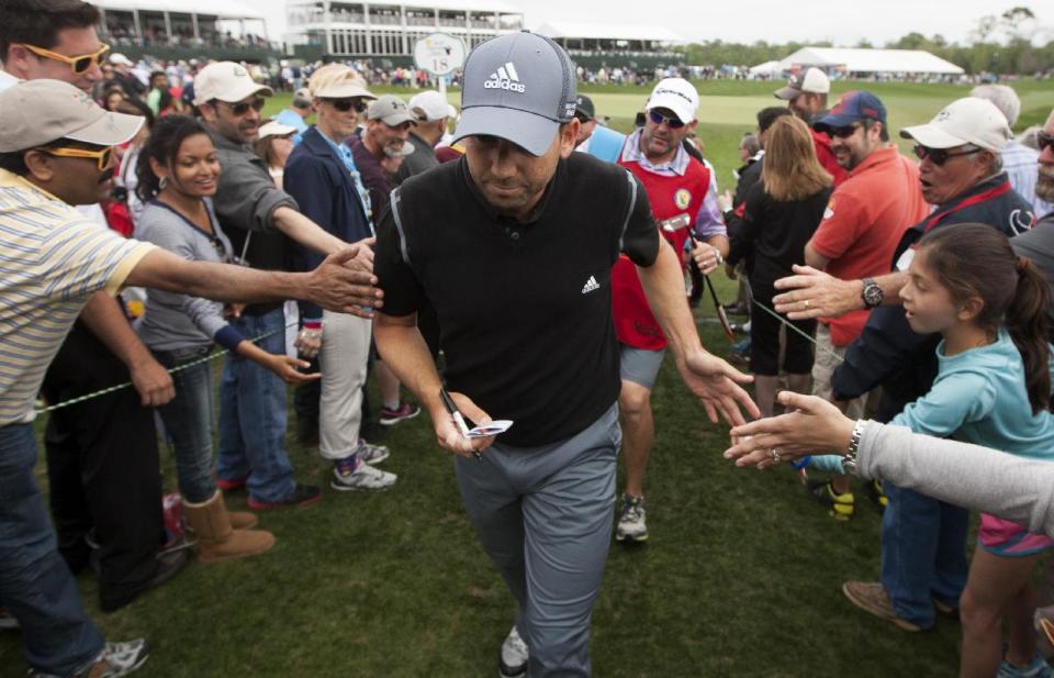 Sergio Garcia is greeted by fans as he walks off the eighteenth green during the third round of the Houston Open golf tournament on Saturday, April 5, 2014, in Humble, Texas. (AP Photo/Patric Schneider)