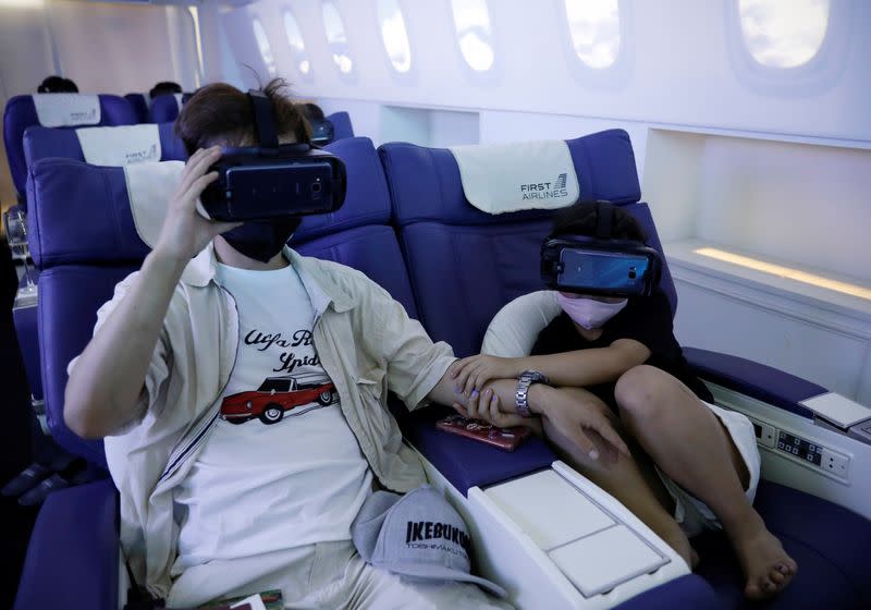 Customers take VR flight experiences at First Airlines in Tokyo