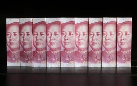 Chinese 100 yuan banknotes are seen in this picture illustration taken in Beijing July 11, 2013. REUTERS/Jason Lee