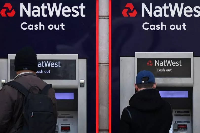 Customers use an ATM machine outside branch of a Natwest bank, in central London, February 14, 2023. (Photo by Justin TALLIS / AFP) (Photo by JUSTIN TALLIS/AFP via Getty Images)