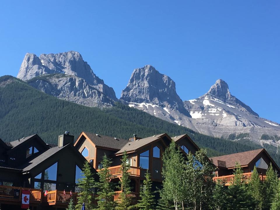 The Three Sisters housing development is shown under the mountain peaks from which it takes its name. 