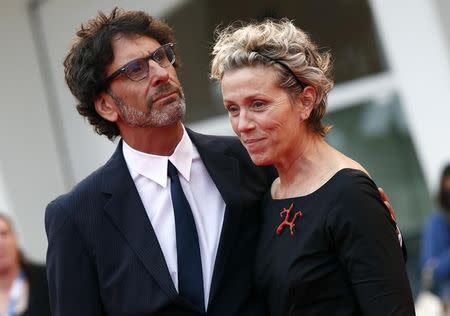 Cast member Frances McDormand (R) and her husband Joel Coen attend the red carpet for the television mini-series "Olive Kitteridge" at the 71st Venice Film Festival September 1 2014. REUTERS/Tony Gentile