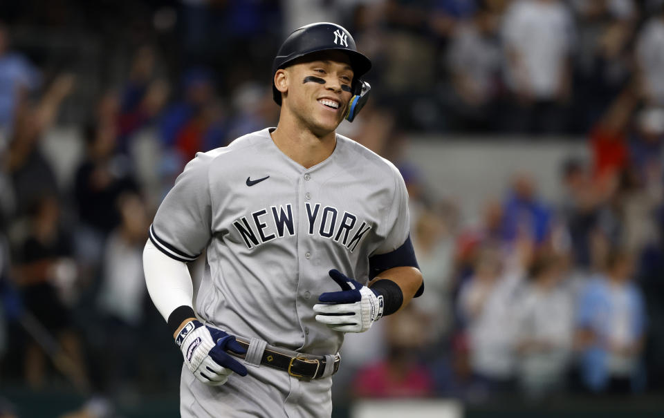 ARLINGTON, TX - OCTOBER 4: 
Aaron Judge #99 of the New York Yankees rounds the bases after hitting his 62nd home run of the season against the Texas Rangers during the first inning in game two of a double header at Globe Life Field on October 4, 2022 in Arlington, Texas. Judge has now set the American League record for home runs in a single season. (Photo by Ron Jenkins/Getty Images)