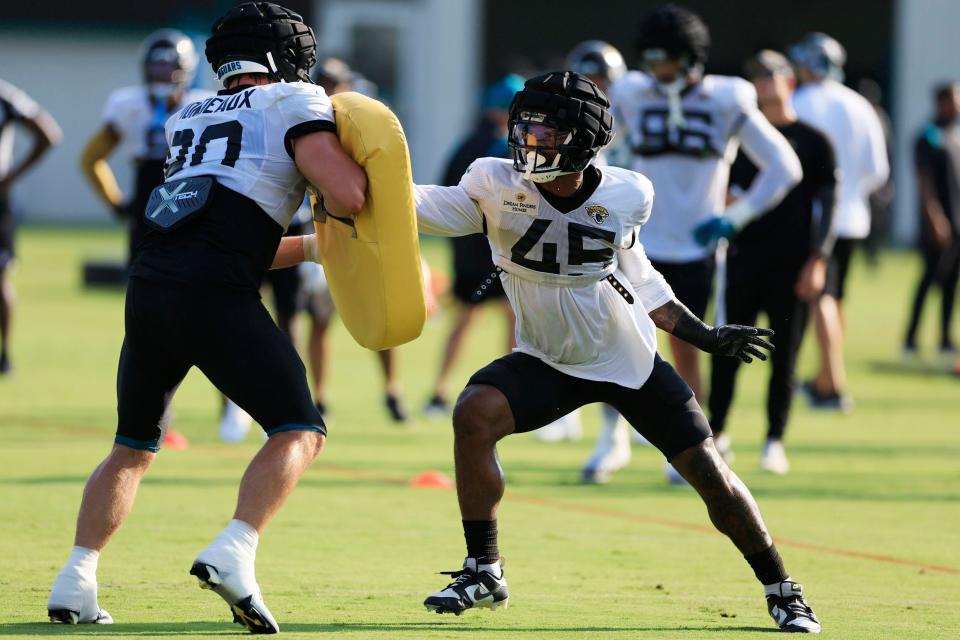 Jacksonville Jaguars linebacker K'Lavon Chaisson (45) is pressured by defensive end Henry Mondeaux (90) Tuesday, Aug. 1, 2023 at Miller Electric Center at EverBank Stadium in Jacksonville, Fla. Today marked the first padded practice. 