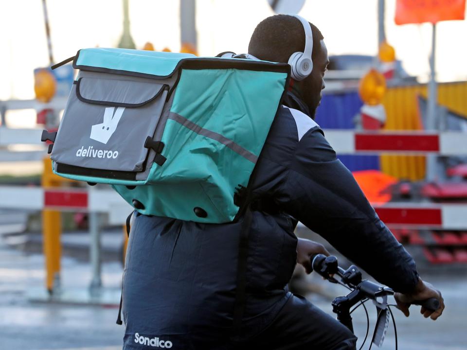 FILE PHOTO: A courier for food delivery service Deliveroo rides a bike in central Brussels, Belgium January 16, 2020. Picture taken January 16, 2020. REUTERS/ Yves Herman