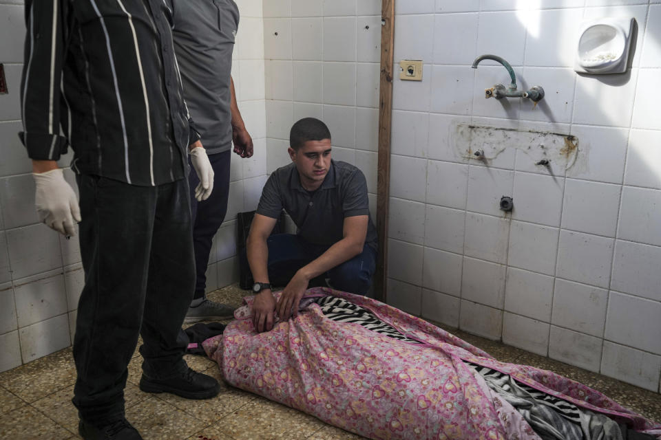 Mourners look at the bodies of Palestinians who were killed in an Israeli airstrike in Gaza Stirp, at the Al Aqsa hospital in Deir al Balah, Gaza, Thursday, May 2, 2024. (AP Photo/Abdel Kareem Hana)