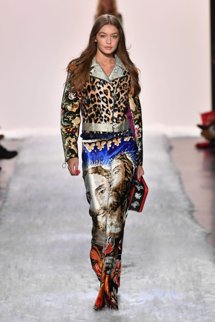 Gigi Hadid models — what else? — Jesus pants on the Jeremy Scott runway. (Photo: Getty Images)