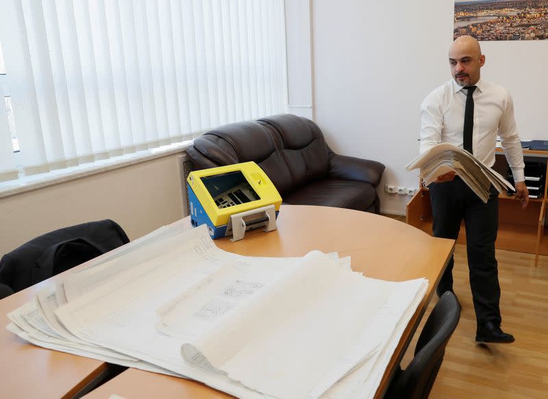 Deputy Director General of Ukroboronprom Nayyem shows instructions and designs of an old ventilator in Kiev