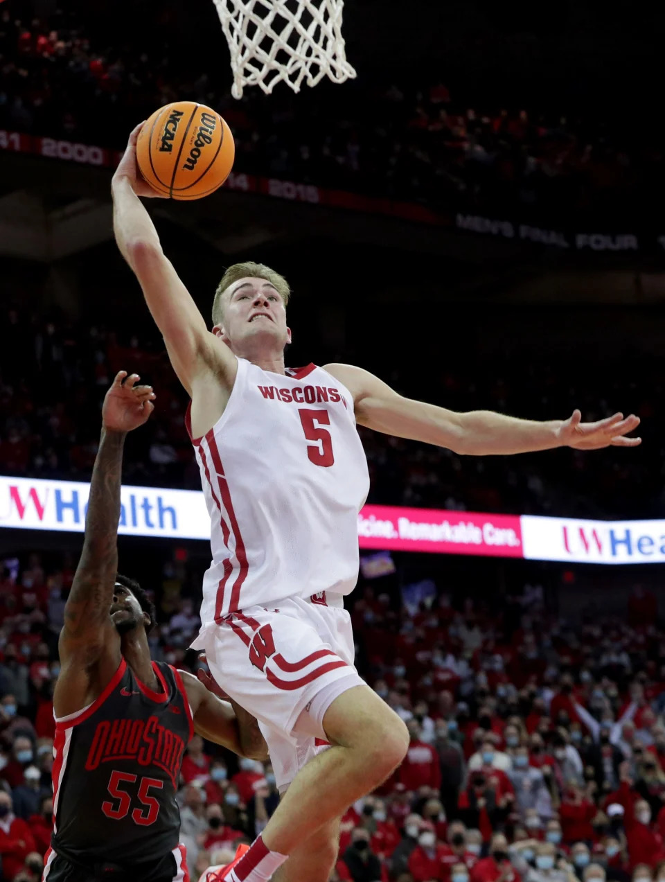 Wisconsin forward Tyler Wahl (5) scores on and is fouled  by Ohio State guard Jamari Wheeler (55) during the second half of their game Thursday, January 13, 2022 at the Kohl Center in Madison, Wis. Wisconsin beat Ohio State 78-68.MARK HOFFMAN/MILWAUKEE JOURNAL SENTINEL