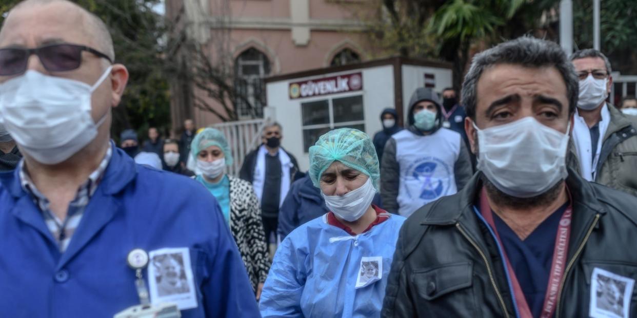 Health workers mourn outside Istanbul University Faculty of Medicine during a commemoration for professor Cemil Tascooglu, the country's first medical professional to pass away from COVID-19, on April 2.