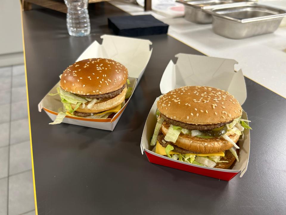 Two Big Mac burgers side by side. On the left is the new version, on the right is the old version.