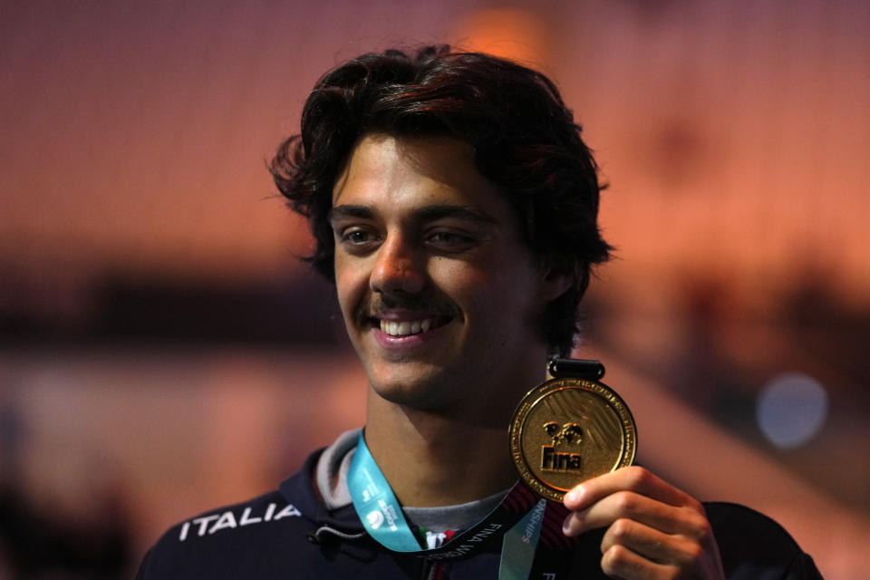 Thomas Ceccon of Italy poses with his medal after winning the Men 100m Backstroke final setting a new world record at the 19th FINA World Championships in Budapest, Hungary, Monday, June 20, 2022. (AP Photo/Petr David Josek)