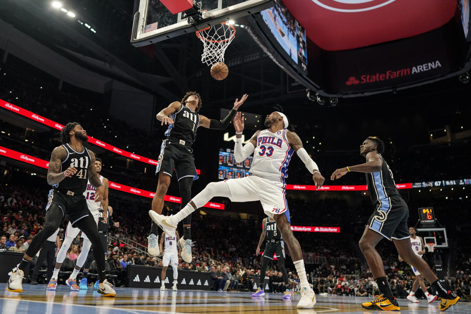 Atlanta Hawks forward Jalen Johnson (1) blocks a shot by Philadelphia 76ers forward Robert Covington (33) during the second half of an In-Season Tournament NBA basketball game, Friday, Nov. 17, 2023, in Atlanta. (AP Photo/Mike Stewart)