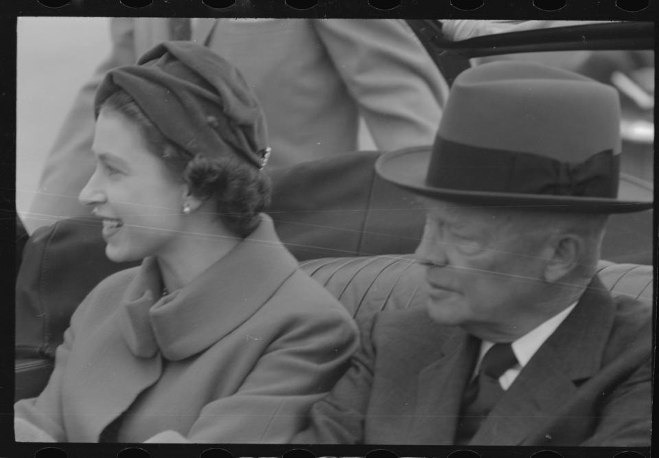 Britain's Queen Elizabeth sits in an open limousine beside President Dwight D.Eisenhower as they await the start of their motorcade into and through Washington, D.C. These were less perilous times when personal security for world leaders was less stringent